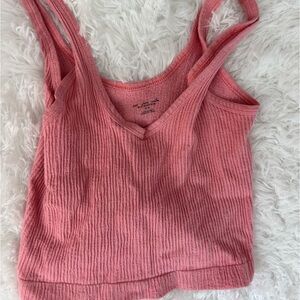 Out from under pink tank top